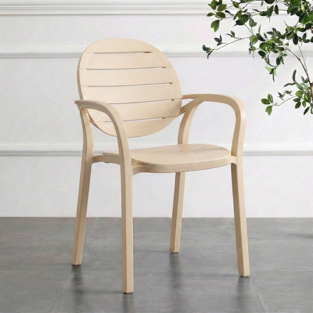 Ash White chair on a gray floor with a white wall and plant in the background
