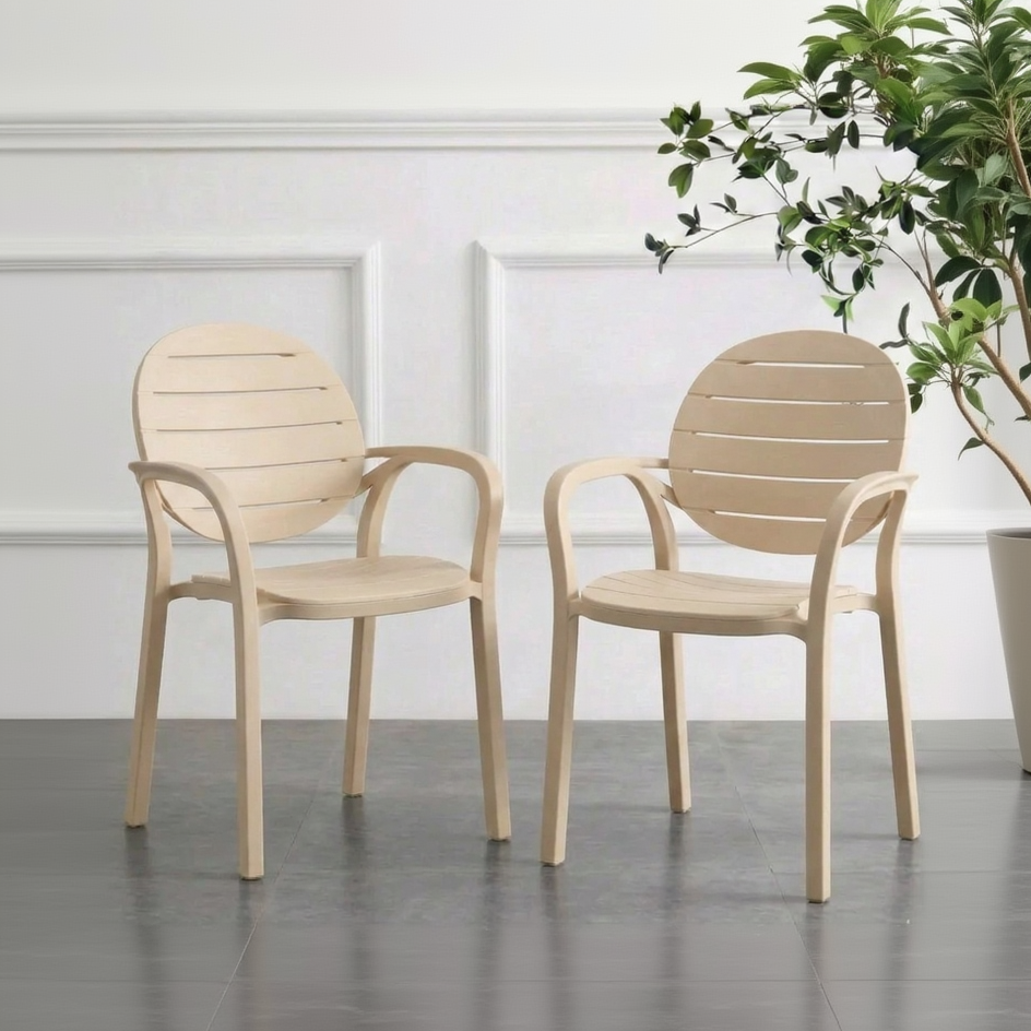 Two Ash White chairs on a gray floor with a white wall and plant in the background